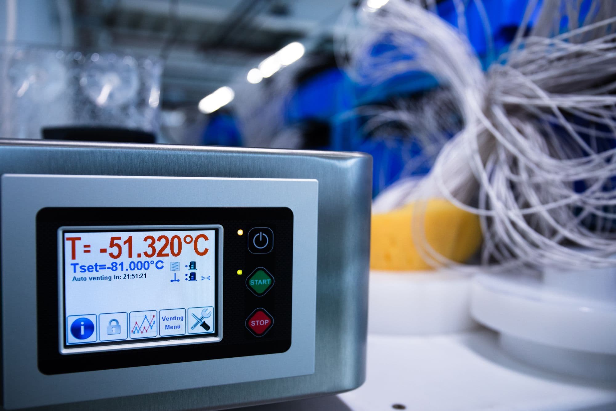 A deep-freeze chamber controller reading minus 51.320°C against a set point of minus 81°C, with probe harnesses behind it