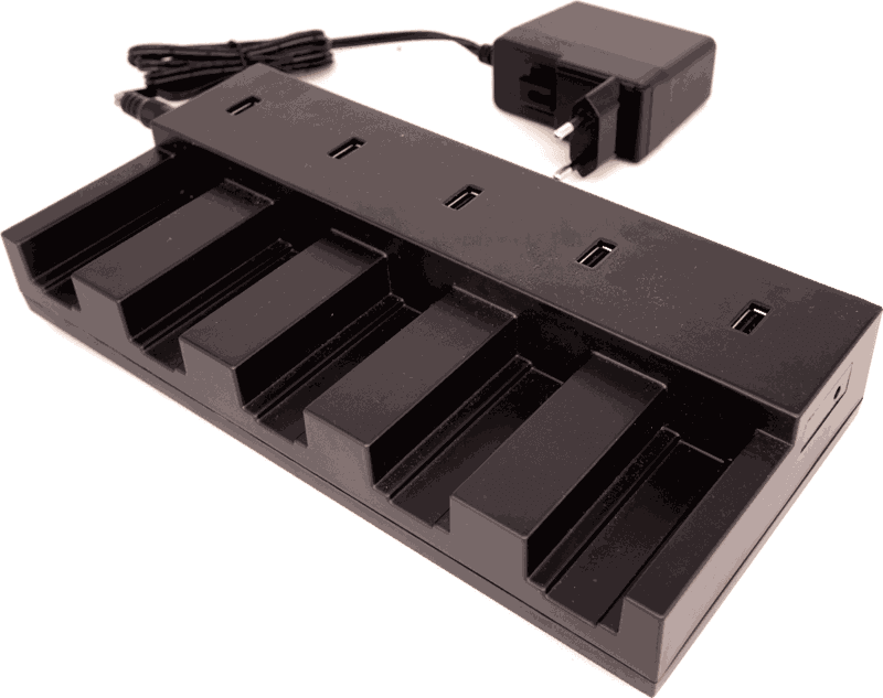 Saga charging station, empty: a black base with five device slots and five USB-A ports along the back, with its plug-in power adapter